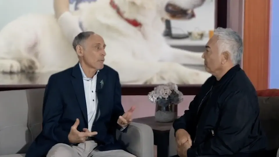 Dr. Marty Goldstein and Cesar Millan talking on a set